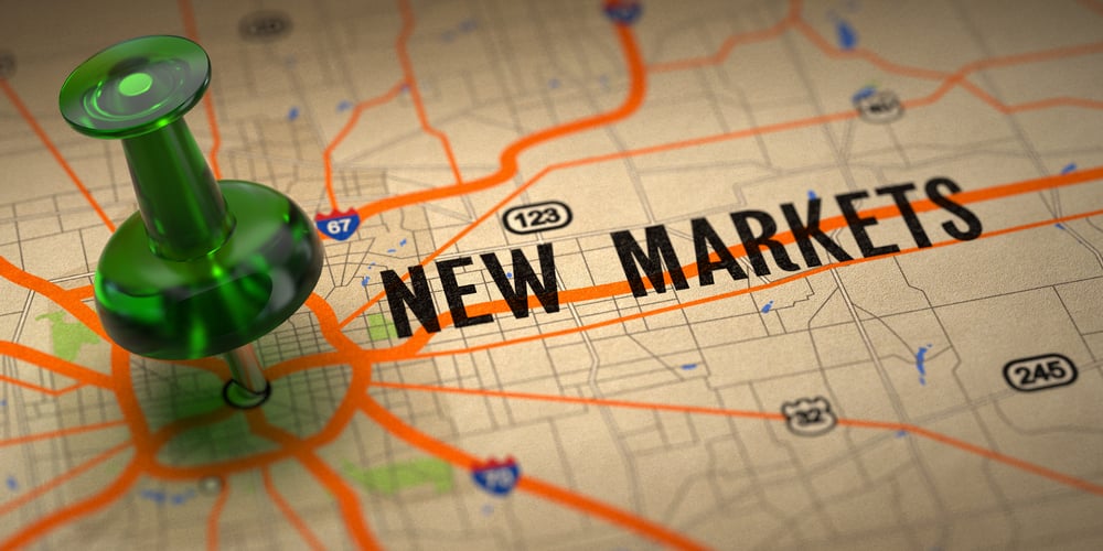 New Markets Concept   Green Pushpin On A Map Background With Selective Focus. 